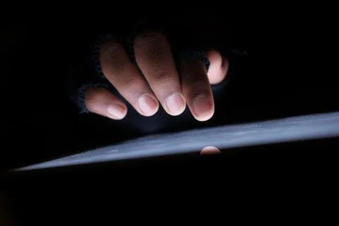 Hacker hand steeling from on digital tablet Stock Photos