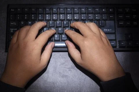 Hacker hand typing on a computer keyboard Stock Photos