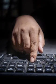 Hacker hand typing on a computer keyboard Stock Photos