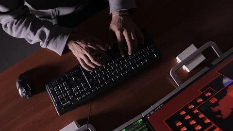 Hacker hands cracking code using computers in dark room Stock Footage 69879465