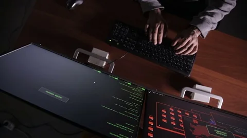 Hacker hands cracking code using computers in dark room Stock Footage 69879475