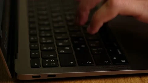 Hacker hands typing code on laptop keyboard, light of police emergency lights. Stock Footage 163658046