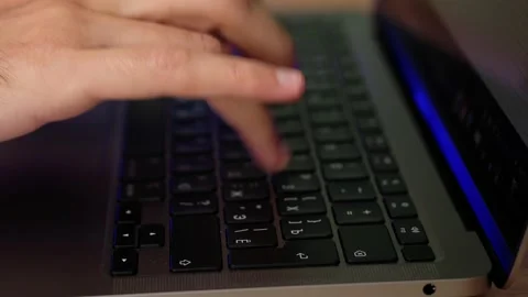 Hacker hands typing code on laptop keyboard, light of police emergency lights. Stock-Footage 163660249