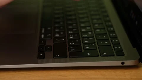 Hacker hands typing code on laptop keyboard, light of police emergency lights. Stock Footage 185671577