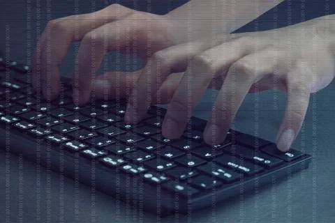 Hacker hands typing on computer keyboard 写真素材