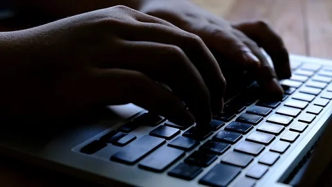 Hacker hands typing on laptop keypad dark tone video. Stock Footage 96325867