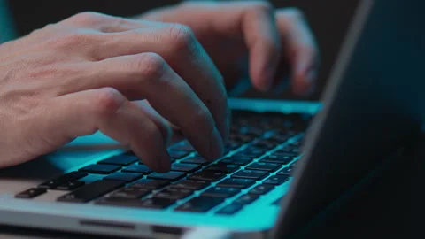 Hacker hands typing on modern laptop keyboard in dark room with dramatic Stock Footage 342761807