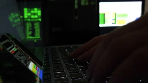 Hacker hands writing codes and Breaking Into Data Servers or stock market Stock Footage 140454497