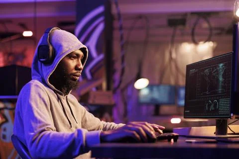 Hacker in headphones writing code Stock Photos