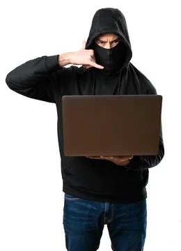 Hacker with his computer making phone gesture on isolated white background 스톡 사진