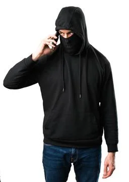 Hacker with his mobile on isolated white background 写真素材