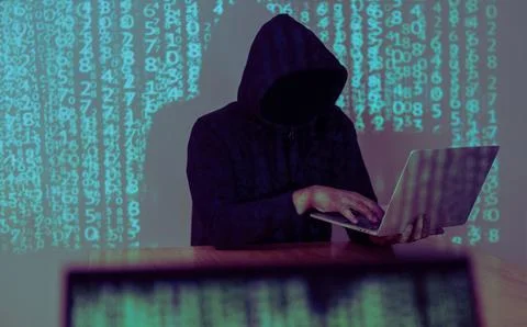 Hacker holding and using laptop over binary code digital background. Hackin.. 库存照片