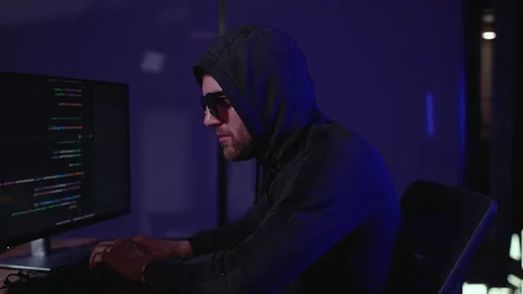 Hacker holding finger on lips. Programmer writes code for Hacker attack Video stock 266473285