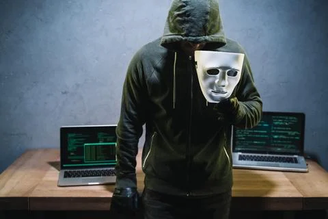 Hacker holding mask Stock Photos