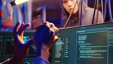 Hacker holding SSD with computer exploit Stock Footage 258620398
