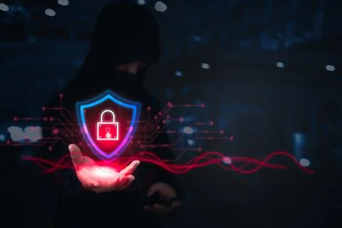 A hacker holds a glowing shield with a digital lock, representing cyber pro.. Stock Photos