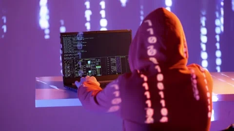 Hacker in hood coding at night with binary projection and command line Stock Footage 307010697