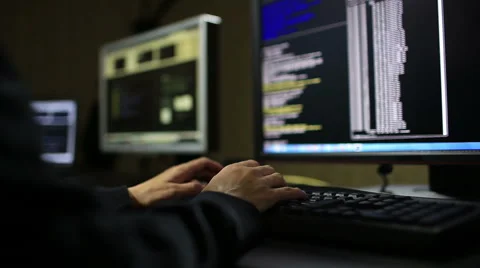 Hacker in hood cracking code using laptop and computers Stock Footage 48767064