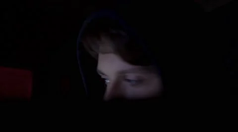 Hacker in hood cracking code using computers in dark room close up Stock Footage 68901517
