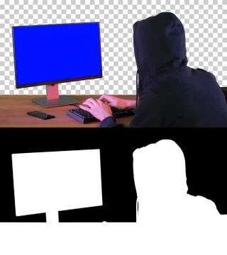 Hacker in hood cracking code using pc, Alpha Channel with Silhou Foto stock