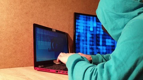 Hacker with a hood. A man in a mask at the computer. Server user Stock Footage 101443158