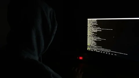 Hacker in the hood programs the code in the dark, the command line on the 스톡 동영상 99327829