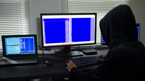 Hacker in hood stealing information Видео 51779848