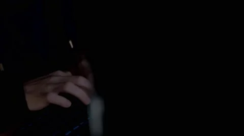 Hacker in hood typing crack code using computers in dark room close up Stock Footage 68906140