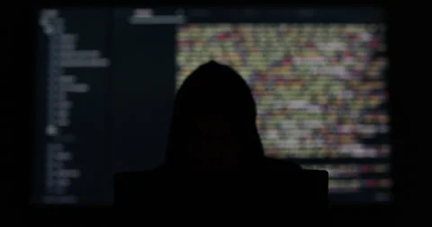 Hacker in hood working in dark abstract room. Programming code on a large screen Stock Footage 278528049