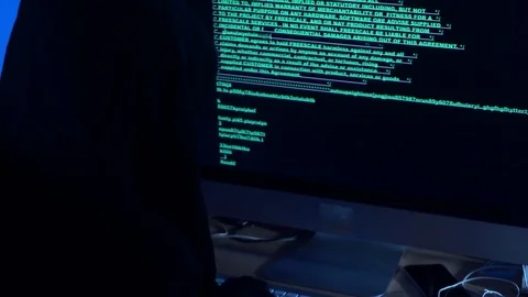 Hacker in the hood write a computer code Stock Footage 77616470