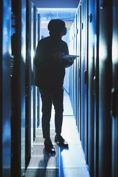 Hacker, hoodie and tablet in data center at night for malware, cyberattack .. Stock Photos