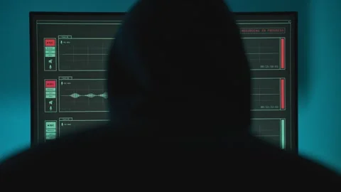Hacker with hoodie looking at computer screen with sound recording application Stock Footage 331308091