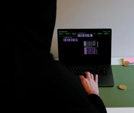 Hacker in Hoodie Running Terminals Command Station Stock Photos