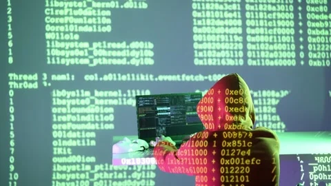 Hacker in hoodie working on terminal with projected green kernel code and hex Stock Footage 307012050