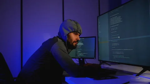 Hacker in hoodie writing code and conducting cyber attack Stock Footage 305008929