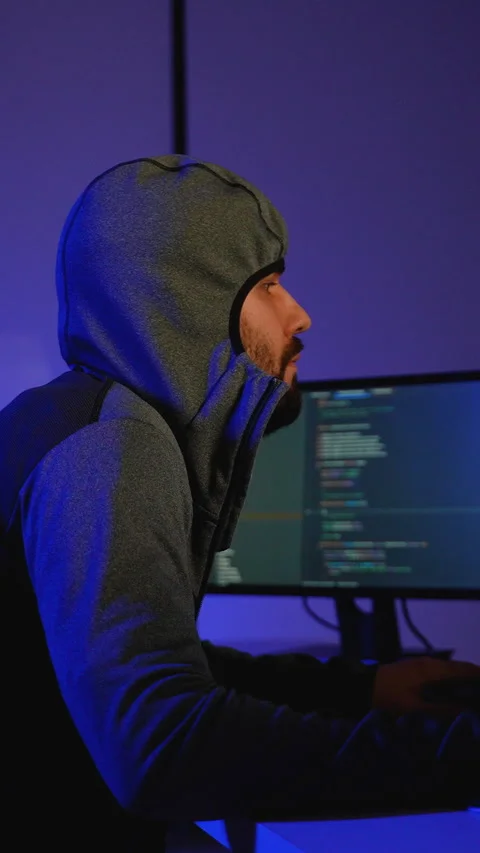 Hacker in hoodie writing code and conducting cyber attack Stock Footage 305022455