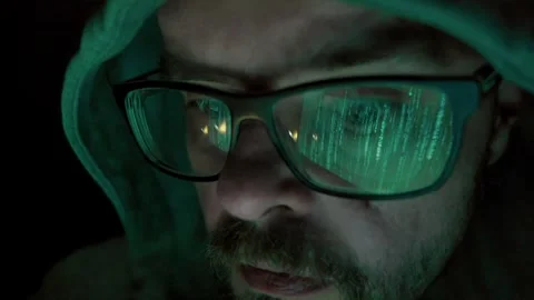 Hacker in hoody with beard and glasses, hacking and coding at night Stock Footage 277439080