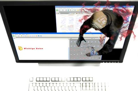 A hacker from the internet is stealing or destroying important data on the ha Stock Photos