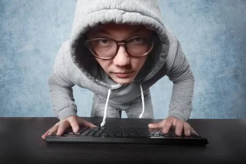 Hacker with keyboard Stock Photos