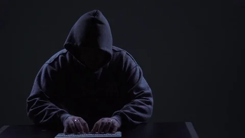 Hacker at Keyboard Wearing Hoodie Stock Footage