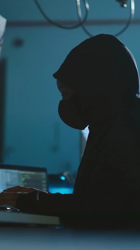 Hacker, laptop and mask in office for software, system or phishing website Vídeos de archivo 333689765