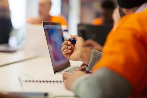 Hacker at laptop coding for charity at hackathon Stock Photos