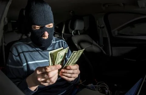 Hacker with a laptop inside a car Stock Photos