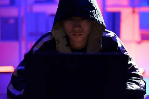 Hacker launching cyberattack targeting data systems and exposing cybersecurit Stock Photos