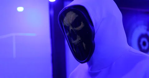 Hacker with LED Mask Working On Computers Stock Footage 260447812