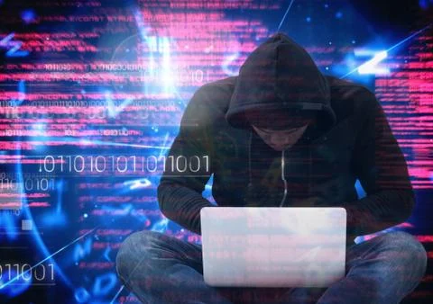 Hacker with legs crossed using a laptop in front of digital background Stock Photos