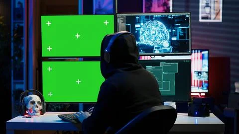 Hacker listening music while using isolated screen PC and AI to steal data Stockfoto's