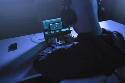 Hacker with loading bar on laptop in dark room 스톡 사진