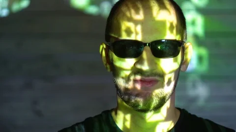 Hacker looking in camera with binary codes from monitor Stock Footage 107382274