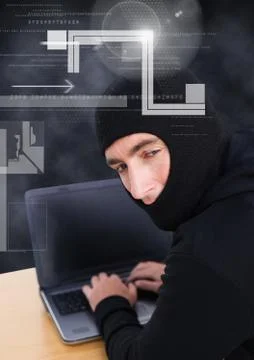 Hacker looking the lens and using a laptop in front of 3D black background Foto stock